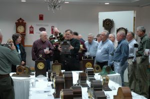 Sangamo expert Les McAlister (center holding clock) conducting a tour of the Sangamo exhibit.