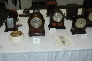 Sangamo electrically wound bracket clocks with visible escapement windows.