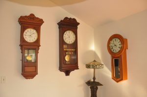 Keyless Clock Company (left), American Clock Company (center), and New YorK Standard Watch Company (right) clocks. Each clock is self winding and powered by batteries.