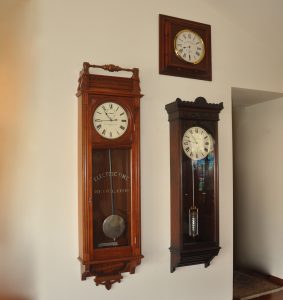 Self Winding Clock Company regulator #13 (left) with a Style B rotary movement, 12 inch dial. Height 73 inches. Telegraphic Time Company master clock (predicesor to Self Winding Clock Company). Equipped with a SWCC Style C rotary movement and master clock contacts to impulse (above) secondary clocks. Mercurial compensated pendulum, 12 inch dial marked "Electric Time". Height 60 inches.