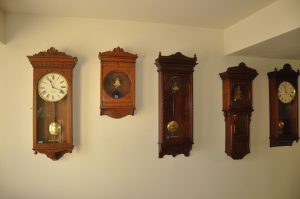 From left, three New York Standard Watch Company clocks, an American Clock Company clock and a Self Winding Clock Company model #8. These clocks are all self winding and are powered by 2 D cell batteries.